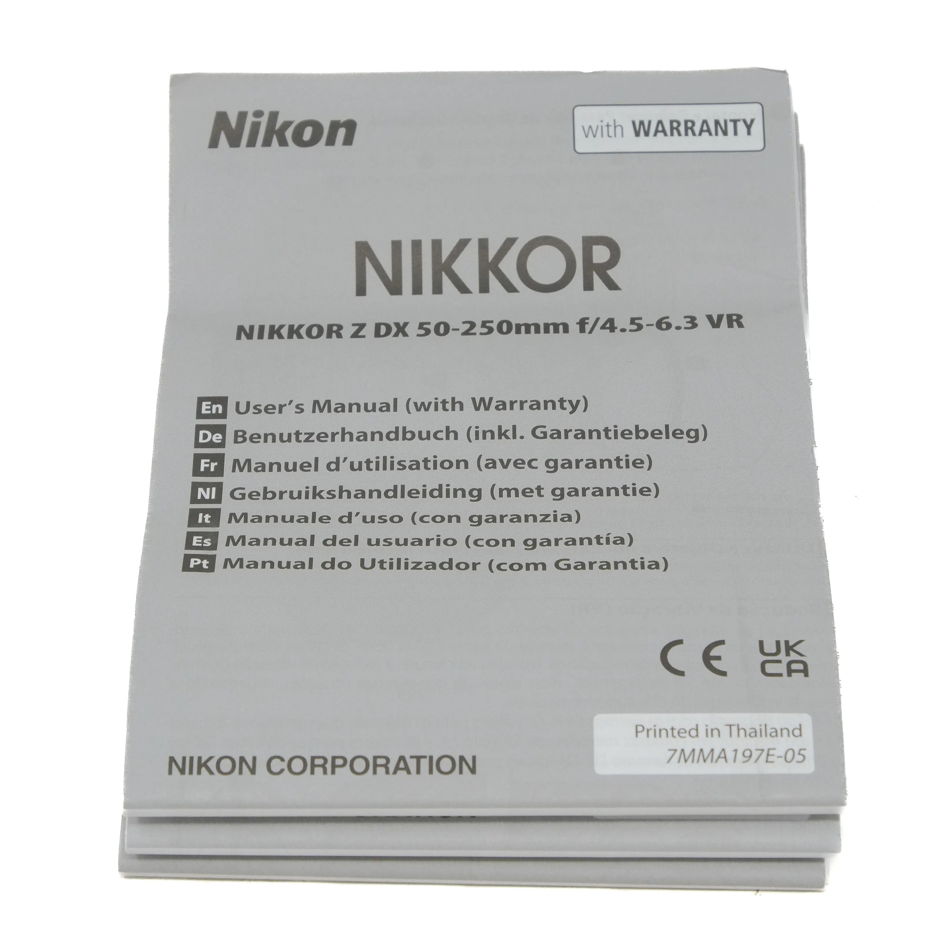 Nikon Nikkor camera lens user manual with warranty information on a white background