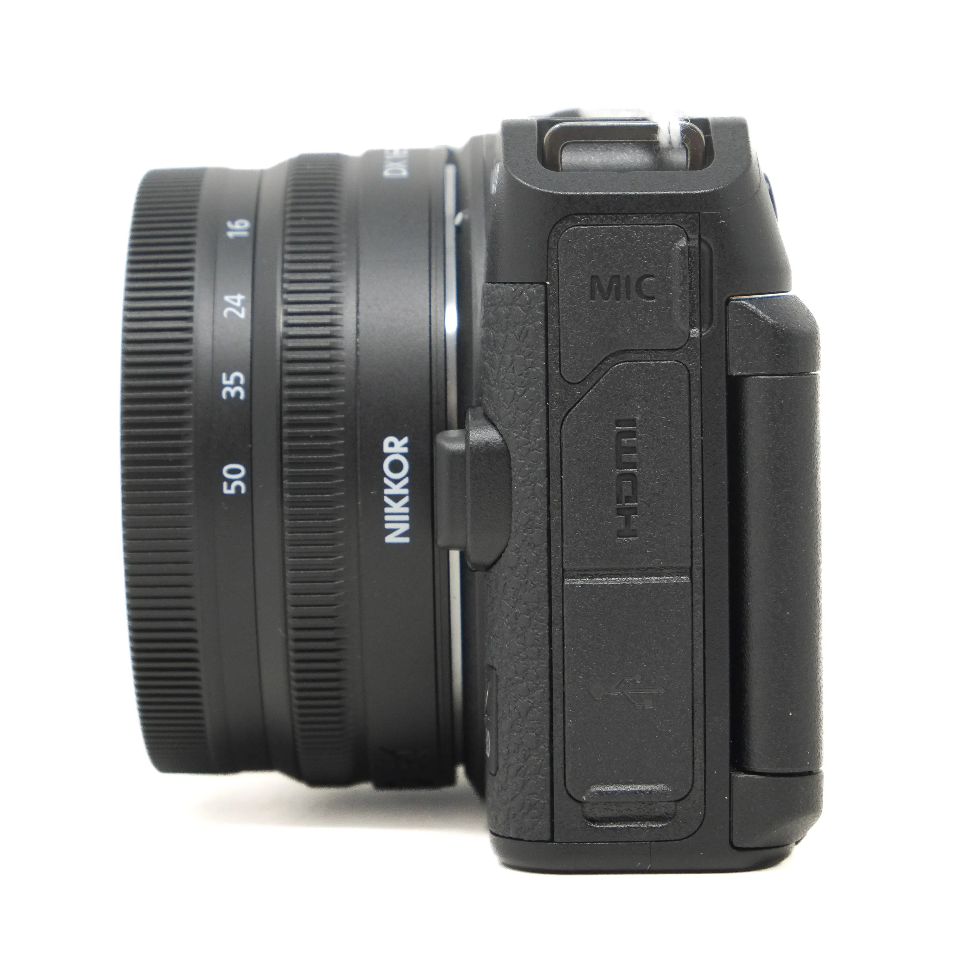 Black camera with Nikkor lens on a white background