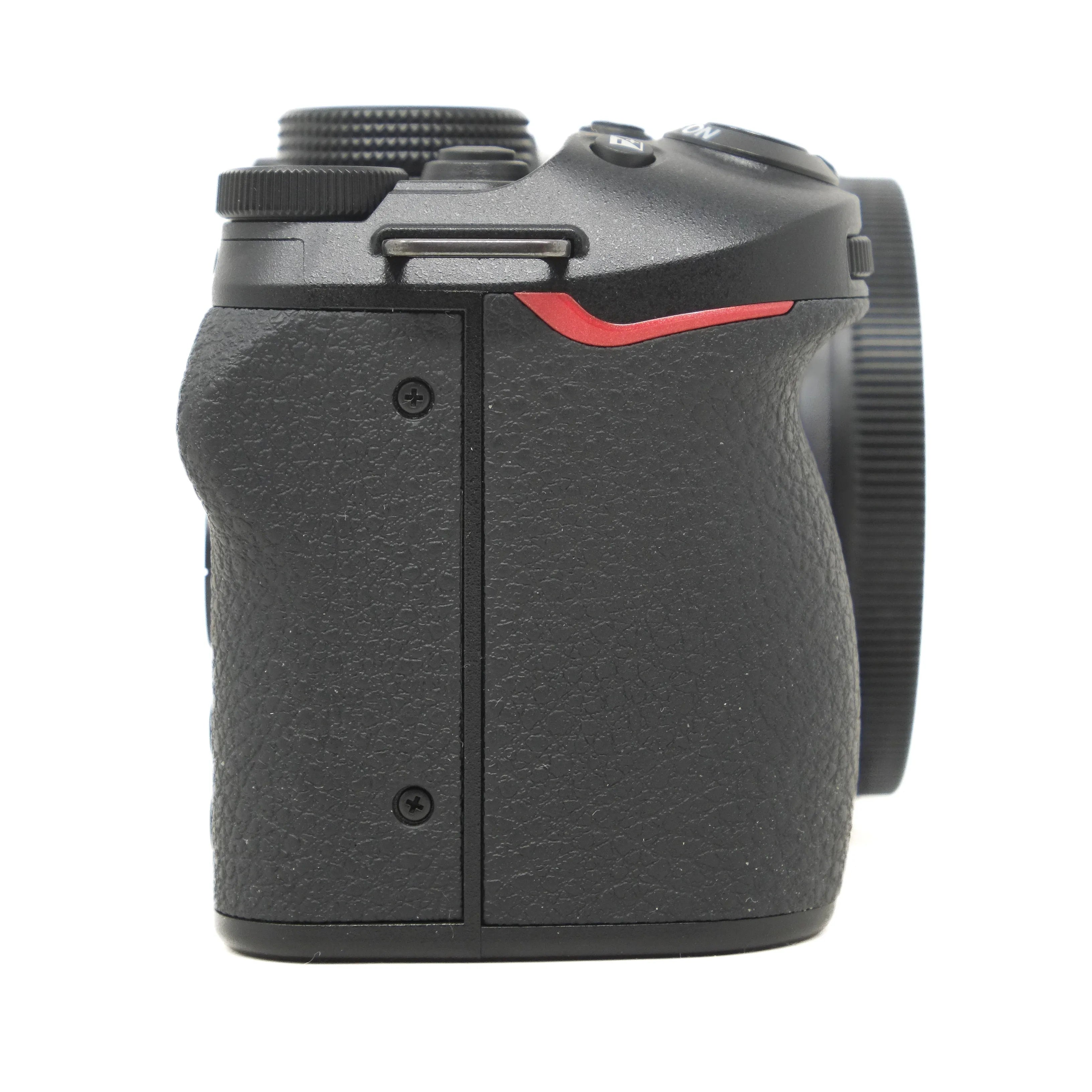 Black camera body with a red accent on a white background