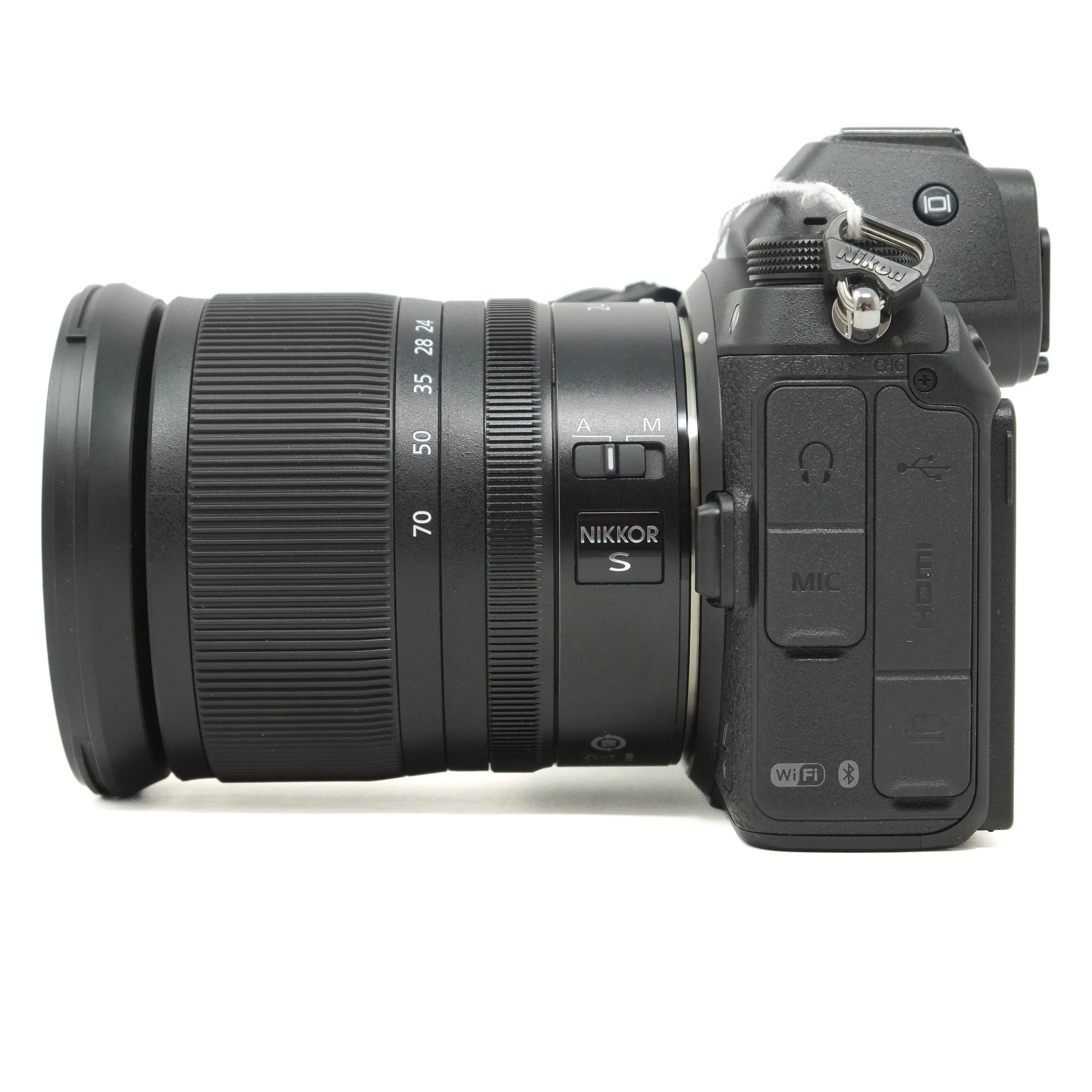 Camera with Nikkor lens on a white background