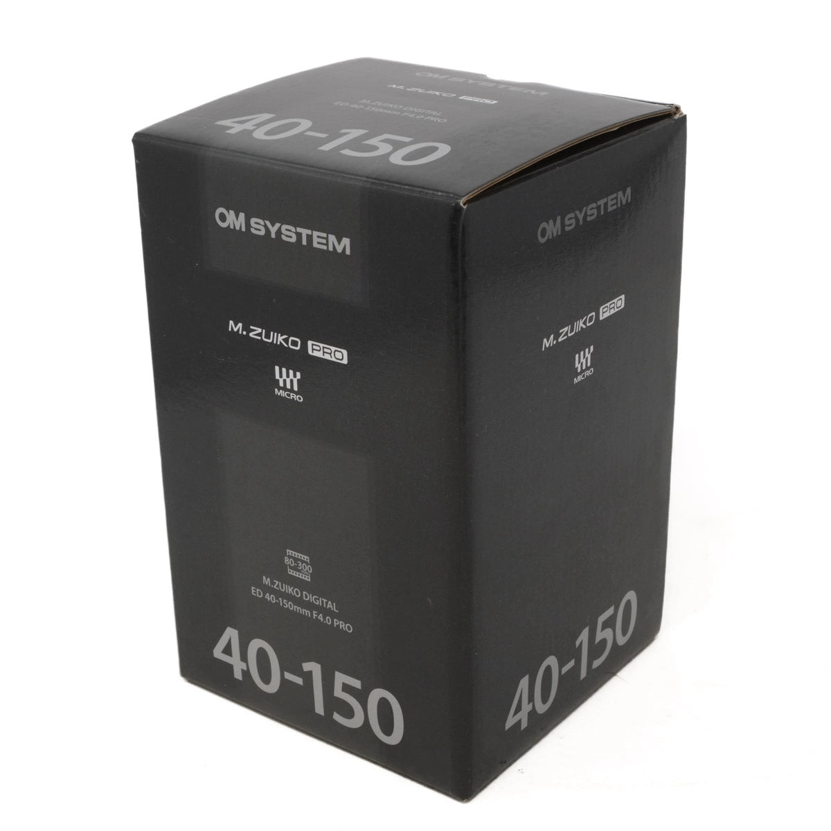 Black camera lens box with 'OM System' and 'M.Zuiko Pro' branding on a white background