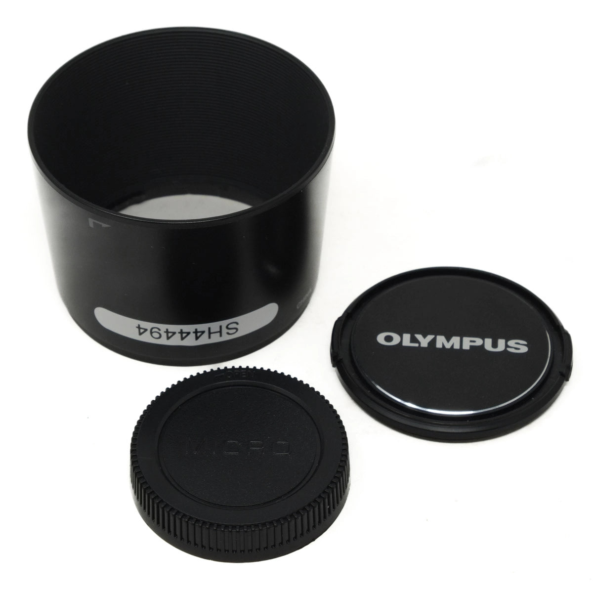 Black camera lens hood and caps on a white background, with 'Olympus' branding.