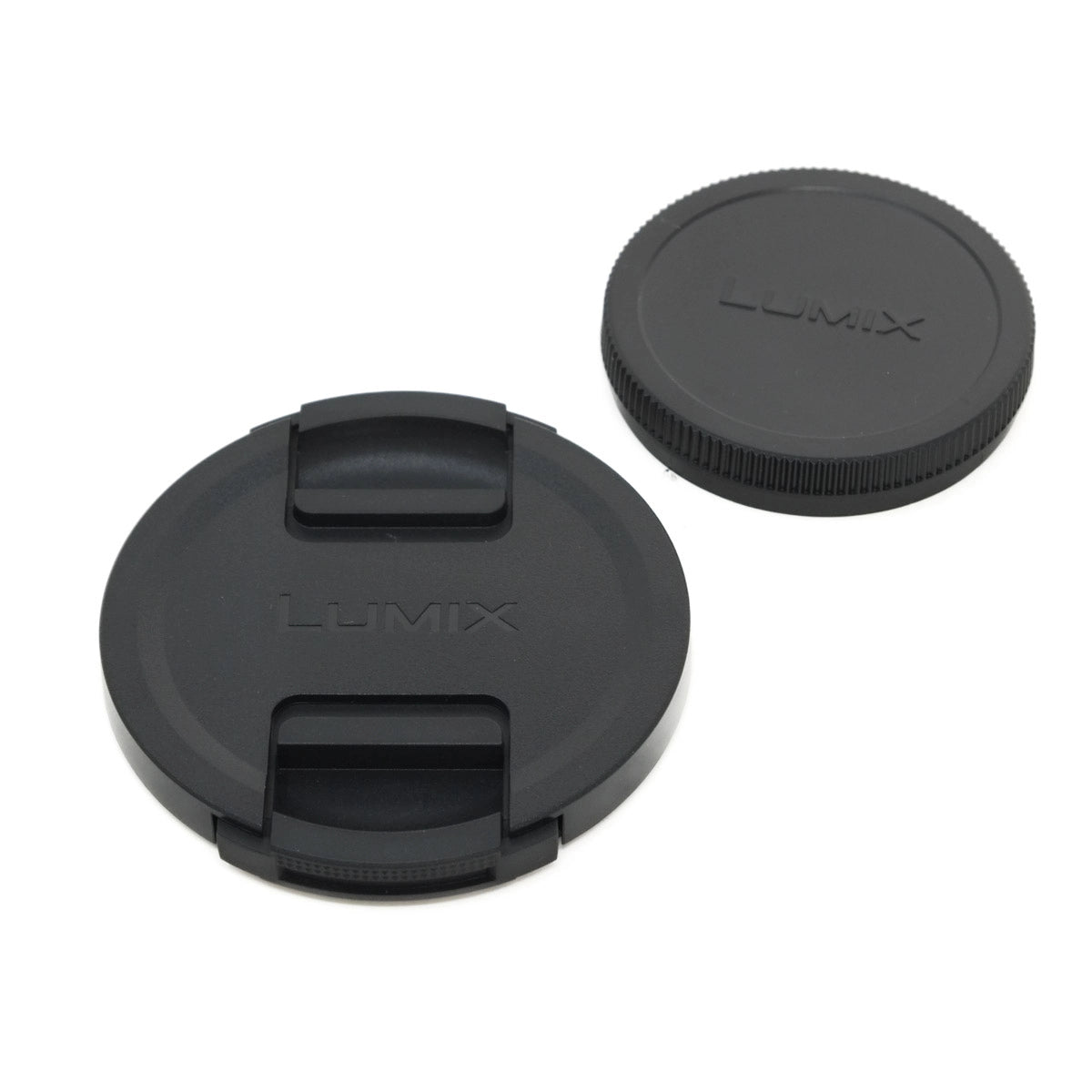 Two black Lumix lens caps on a white background