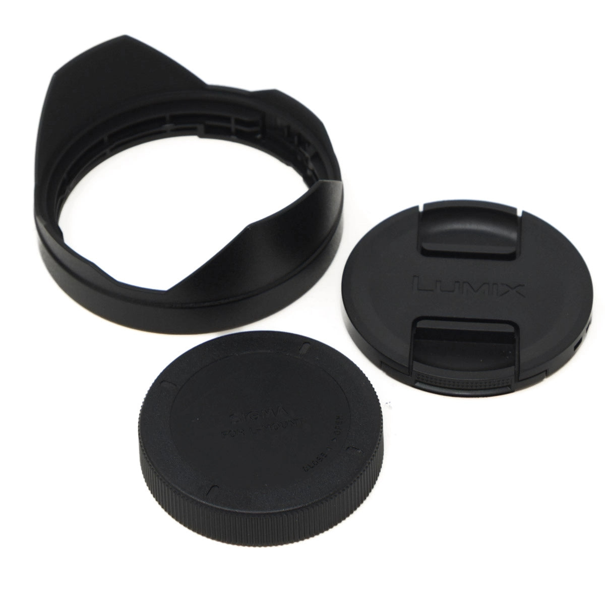Set of black camera lens caps and hood on a white background