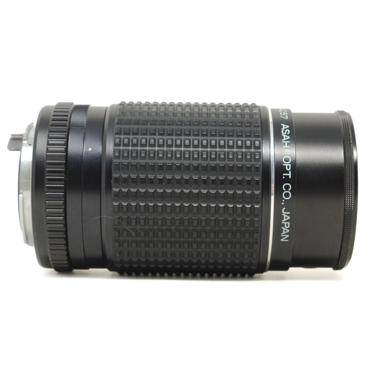 Black camera lens with textured surface on a white background