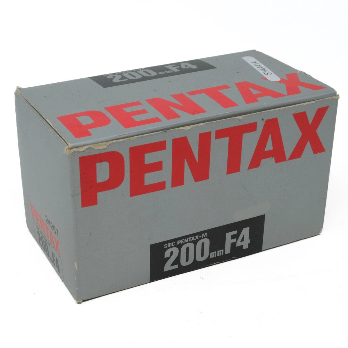 Pentax camera lens box with red and black text on a white background