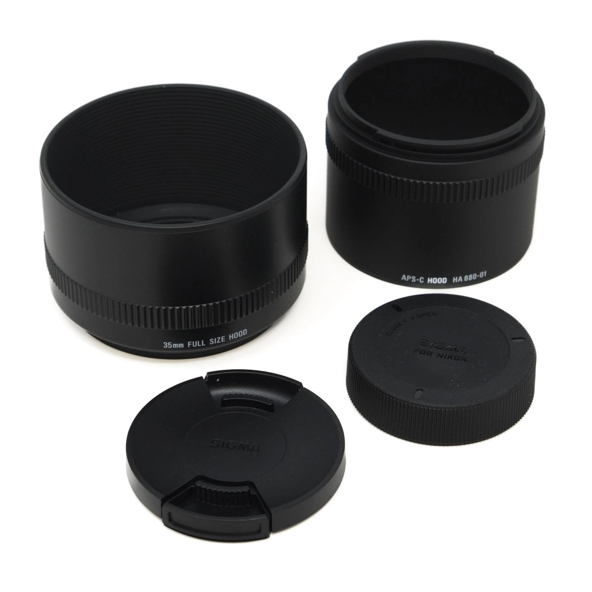 Set of black camera lens components on a white background
