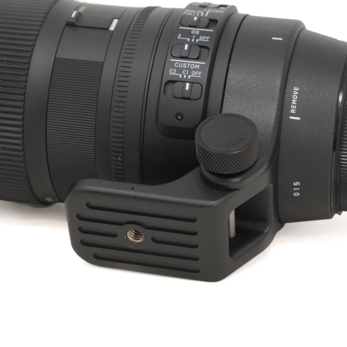 Close-up of a camera lens with control buttons on a white background