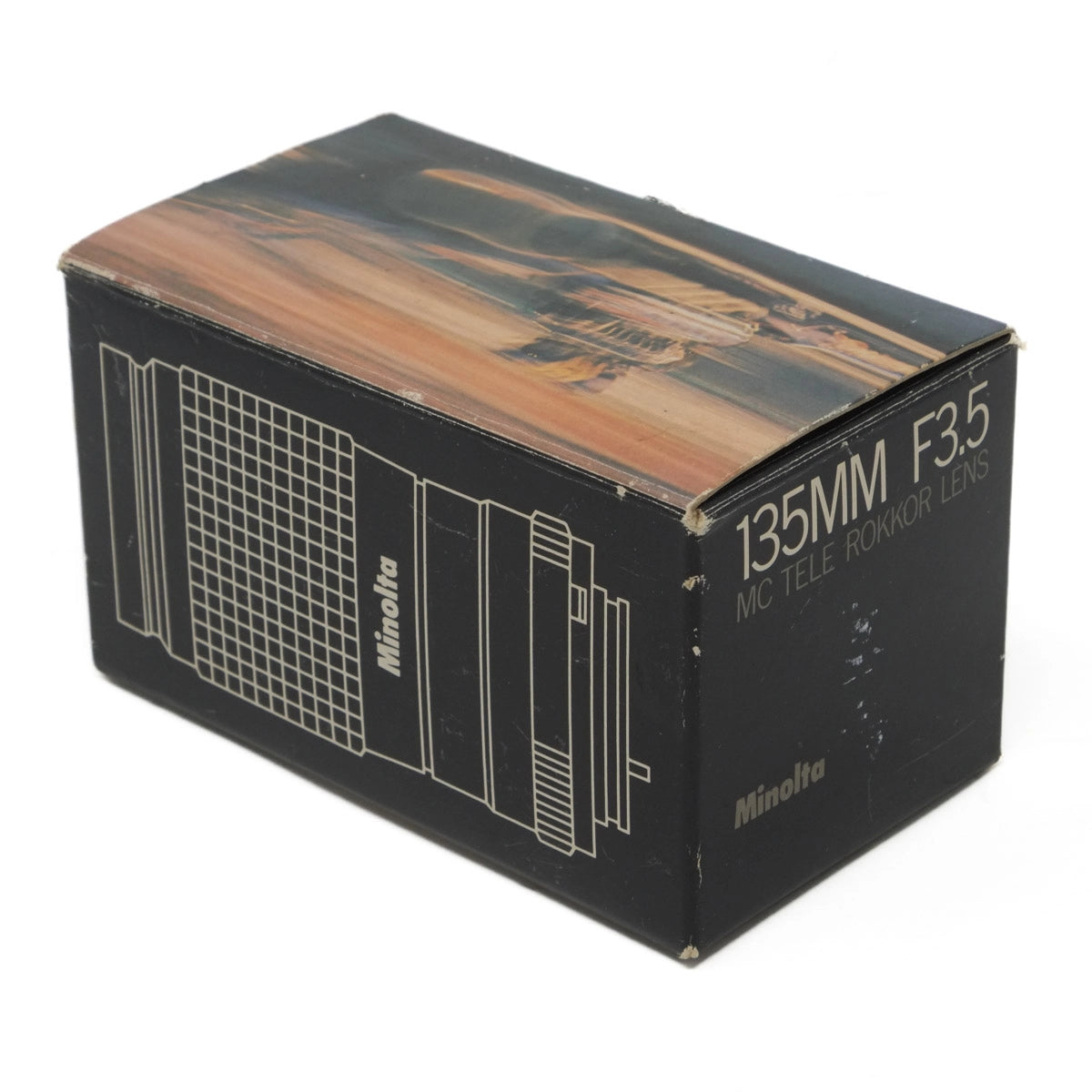 Vintage Minolta camera lens box with '135MM F3.5' text on a white background