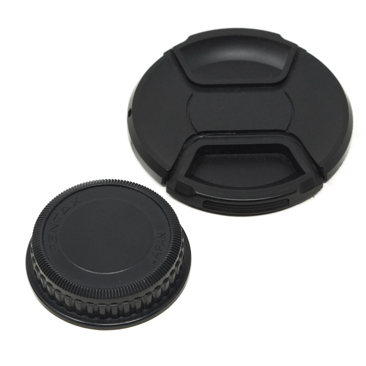 Two black camera lens caps on a white background