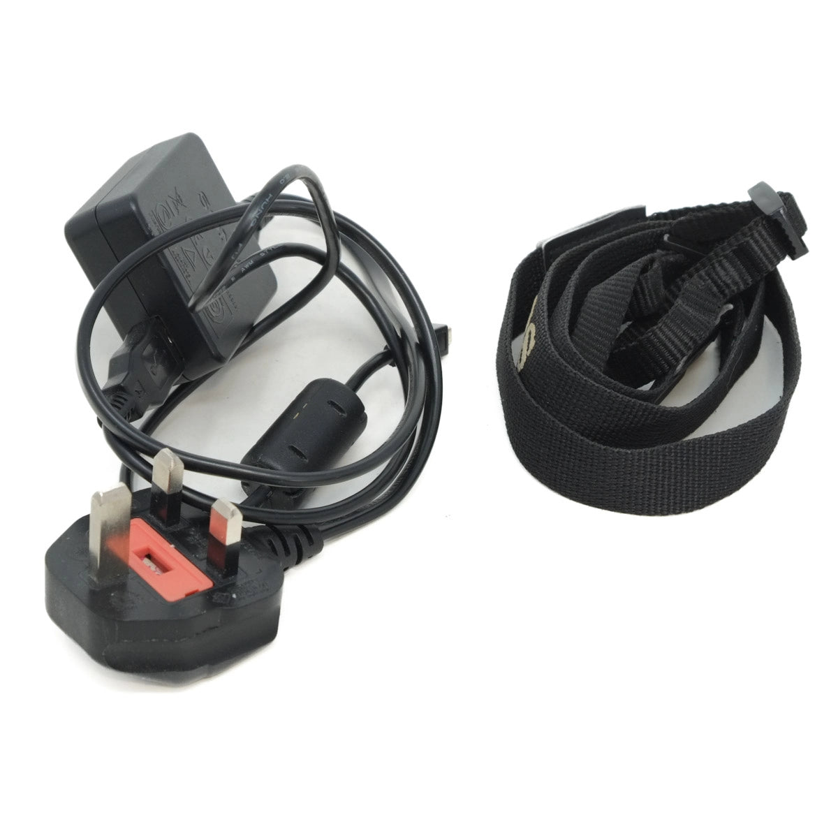 Black electrical plug, black cable, and black strap on a white background
