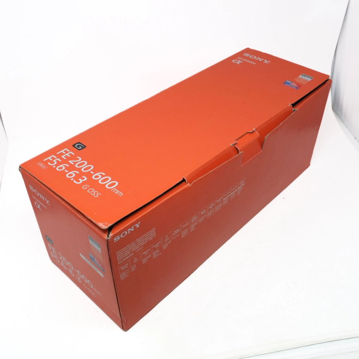 Orange Sony camera lens box on a white background
