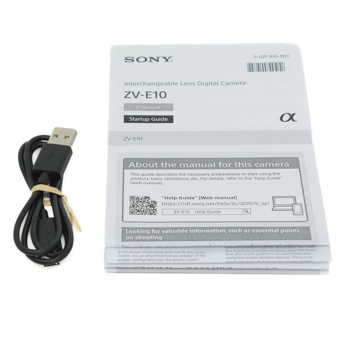 Sony camera manual and USB cable on a white background
