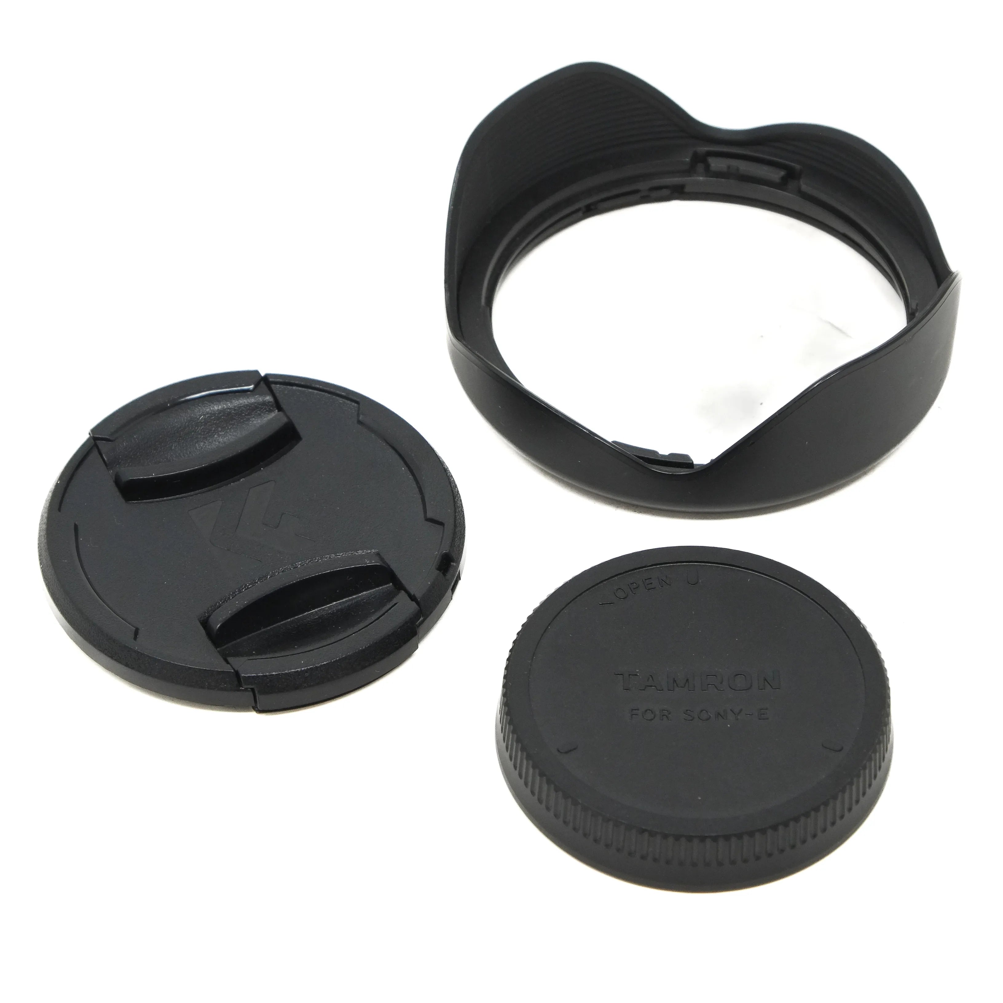Camera lens cap, hood, and body cap on a white background