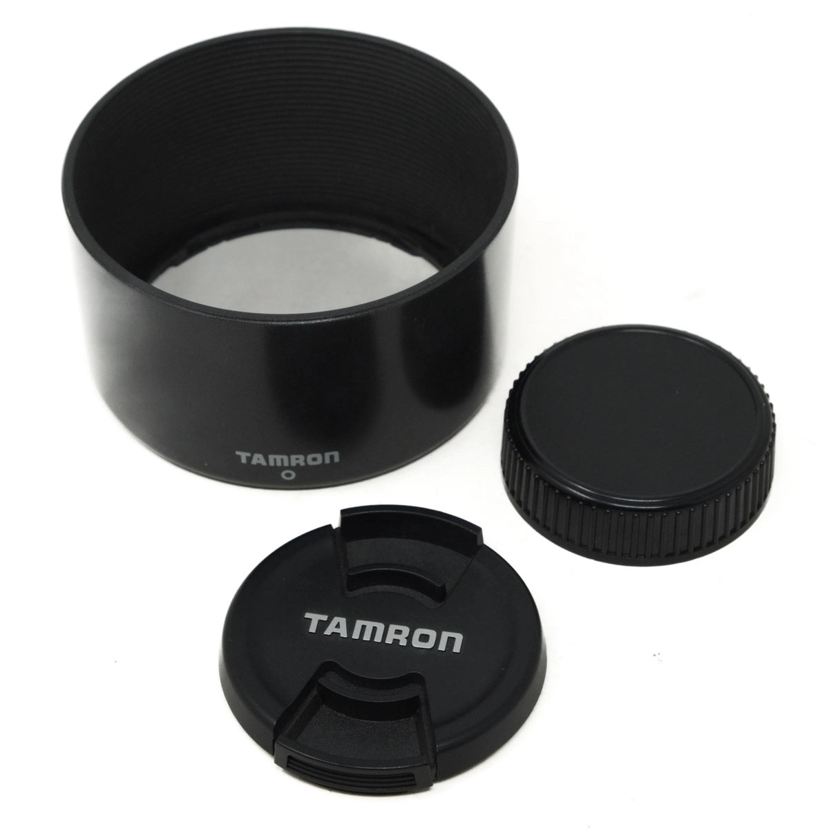 Black camera lens hood and cap with Tamron branding on a white background