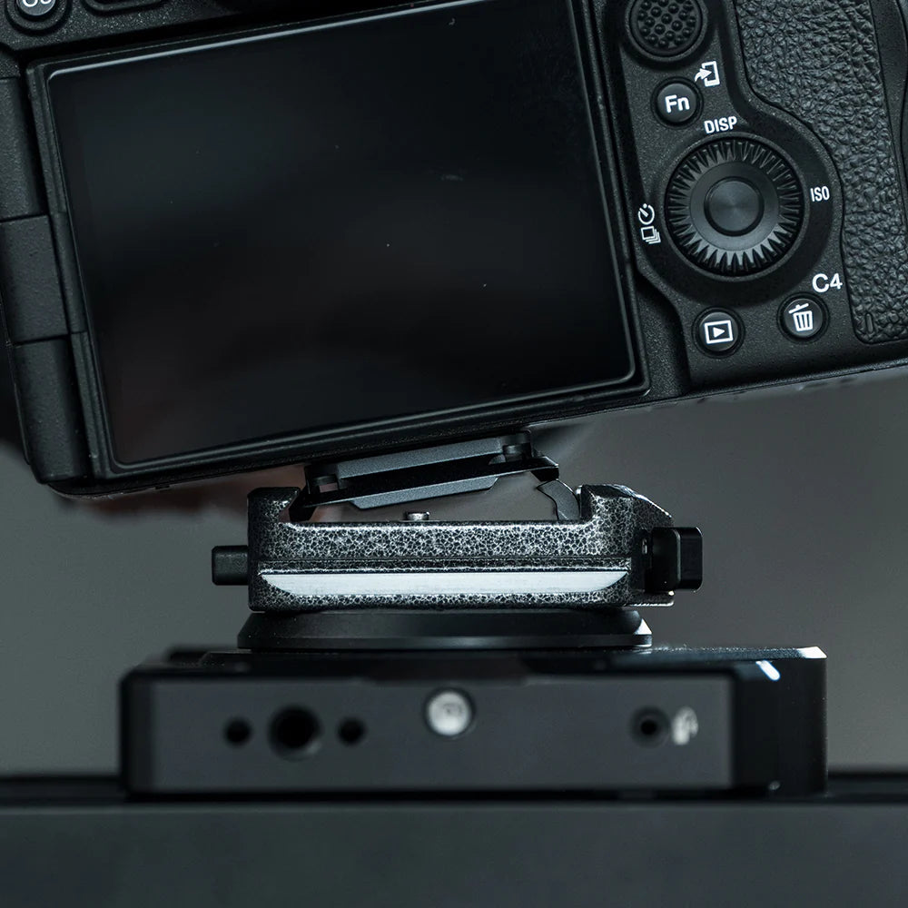 Close-up of a camera with a focus on the lens mount and control buttons.